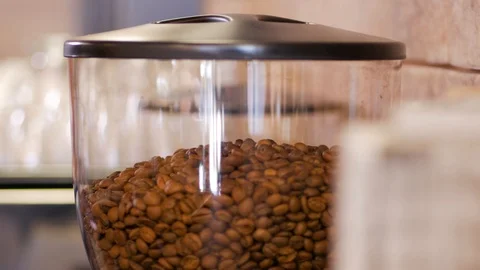 Close up view on pile of robusta arabica coffee beans in coffee grinder machine Stock Footage 105646332