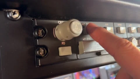 Close-up View of a Pilot Finger Connecting the Autopilot Button in Flight Stock Footage 328966897