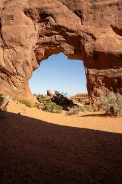 A close-up view of Pine Tree Arch on a sunny day in Arches National Park, Utah. Stock Photos