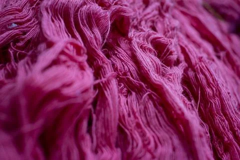 Close view of the pink color thread yarns used in textile industry Stock Photos