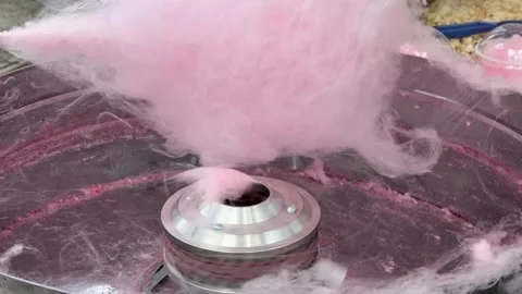 A close-up view of pink cotton candy being spun Stock Footage 312400610