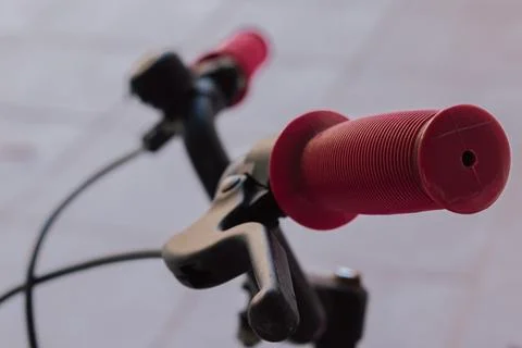 Close up view of pink rubber grip and black brake lever on handlebar of old.. Stock Photos