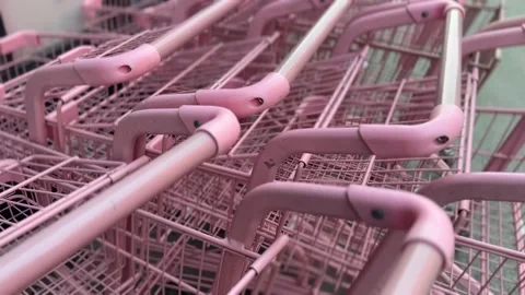 Close-up view of pink shopping carts lined up in a row Stock Footage 312095460