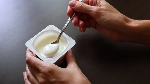 Close up view of plain greek yogurt in a plastic cup. Stock Footage 310626388