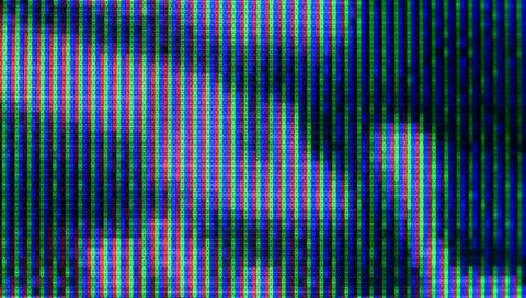 Close up view at a plasma tv while showing television activity. Stock Photos