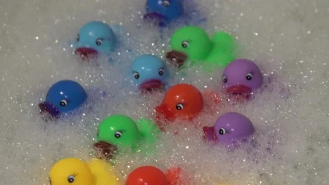 Close up view to plastic rubber duck in bathroom bath in foam water Видео 134273815
