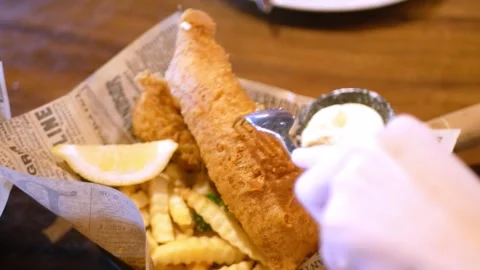 Close up view to a plate of fish and chips with tartar sauce while using fo.. Stock Footage 274214370
