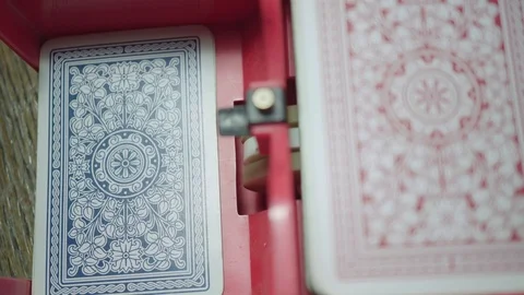Close-up view of playing cards being mixed by a mixing machine Stock Footage 98414082