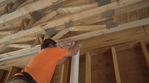 Close-up view as a plumber joints a PVC plumbing pipe at the construction site Stock-Footage 317590975