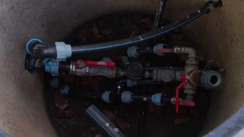 Close-up view of plumbing components in a circular tank, showcasing intricate Stock Footage 323231722