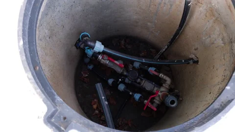 Close-up view of plumbing components inside a maintenance access point Stock Footage 323233500