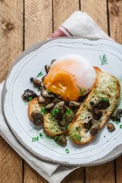 Close view of poached egg with wild mushrooms and toasted bread Stock Photos