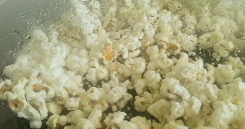 Close up view of popcorn popping inside a closed pan, concept of fun Stock Footage 284234217