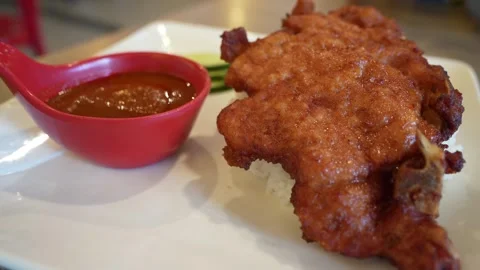 Close-up view of the pork chop with rice, cucumber and sambal sauce. Stockbeeldmateriaal 242092132