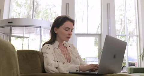 Close up view of positive female freelancer work on laptop computer at the hotel Stock Footage 154336095