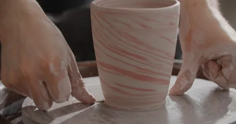 Close up view: potter separates the molded nerikomi pot from the potter's wheel Stock Footage 151106722