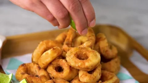 Close-up view of pouring delicious mixed seafood dish with fresh lemon juice. Stock Footage 265840393