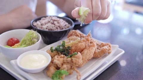 Close-up view of pouring delicious mixed seafood dish with fresh lemon juice. Stock Footage 265840998