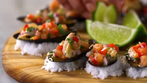 Close-up view of pouring delicious mixed seafood dish with fresh lemon juice. Stock Footage 265841287