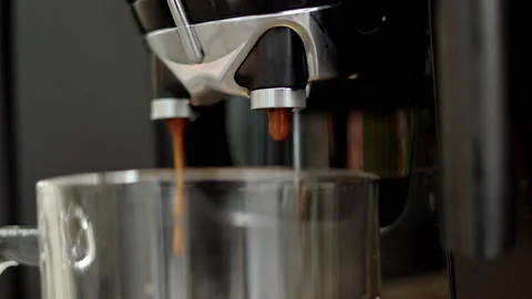 Close up view of pouring liquid coffee from automatic coffee machine with Stock Footage 176338677