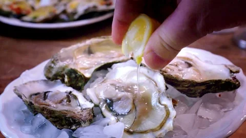 Close-up view of pouring mixed seafood dish with lemon juice. mussels in sh.. Stock Footage 265841710