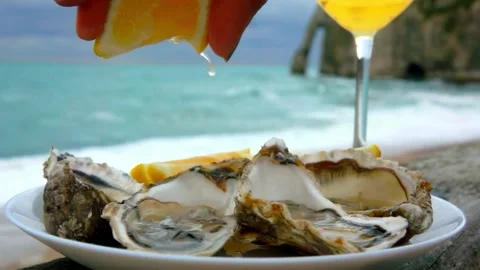 Close-up view of pouring mixed seafood dish with lemon juice. mussels in shells Stock Footage 336588774