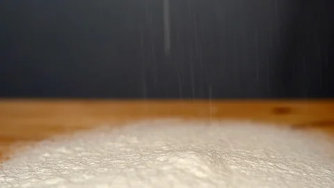 Close-up view of pouring white wheat flour on wooden board. Bakery process Stock Footage 111029456