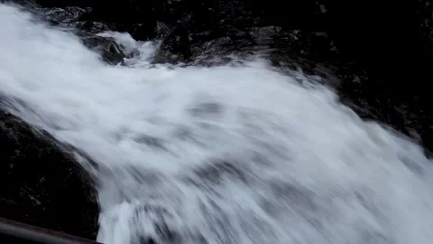 Close-up view of a powerful mountain waterfall with fast-moving water Stock Footage 311138120