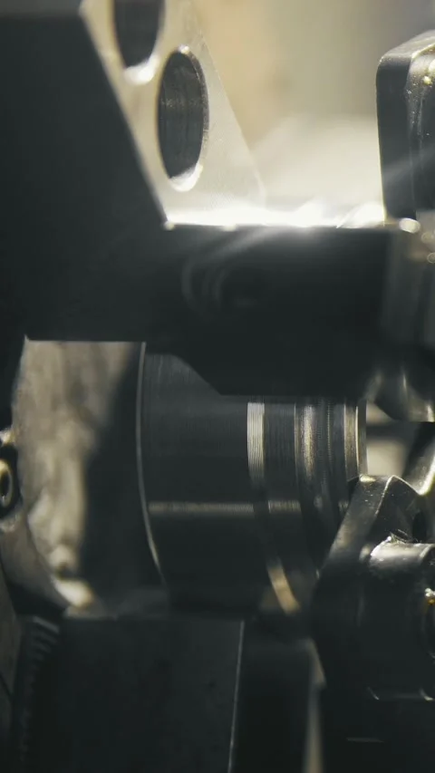 Close-up view of precision machining process showing metal components being Stock Footage 336246898
