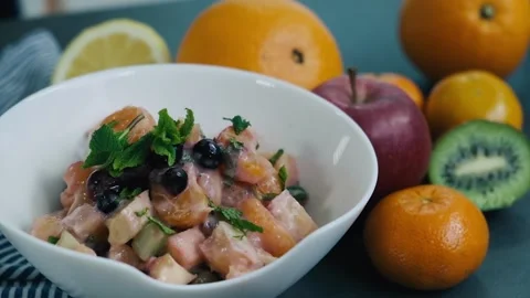 Close view on the prepared fruit salad with kiwi, oranges, apples, berries Stock Footage 136674452