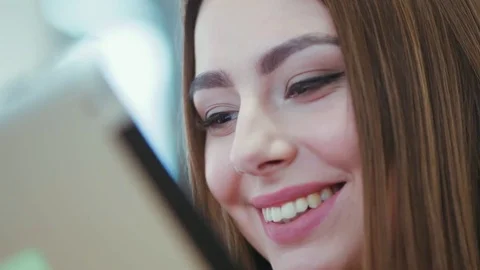 Close up view of a pretty female face smiling happily and drinking coffee while Stock Footage 77054829