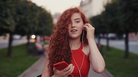 Close up view of pretty ginger student girl with smile on her face turning on Stock Footage 115670038