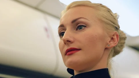 Close up view of pretty smiling young flight attendant with accurate makeup Stock Footage