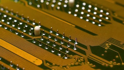 Close-up view of a printed circuit board showing intricate copper traces and Stock Footage 330486254