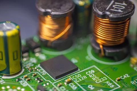 Close-up view of a printed circuit board featuring capacitors, inductors, a.. Stock Photos