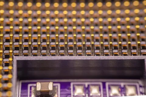 Close-up view of a printed circuit board with gold-plated pins and electron.. Stock Photos