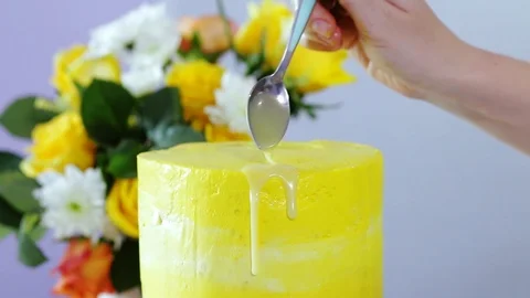Close up view of the process of decorating the wedding cake with liquid glaze Stock Footage 102932082