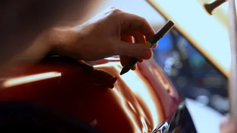 Close up view of Process of pointless dent repair on car body, mechanic at the Stock Footage 317208108