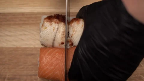 Close-up view of process of preparing rolling sushi with salmon and eel. Making Stock Footage 249393602