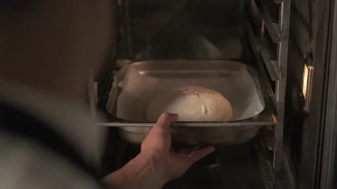 Close up view of the process of putting the dough bread into the oven. Baker Stockbeeldmateriaal 139152206