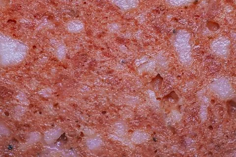 Close-up view of processed meat product texture showcasing a blend of pink .. Stock Photos