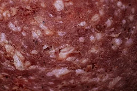 Close-up view of processed meat texture showing visible fat and meat partic.. Stock Photos