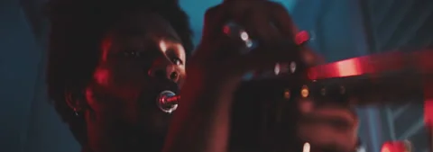 Close up view of a professional trumpeter playing with red neon lights Stock Footage 202309139