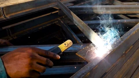 Close up view of a professional welder joining structural steel components with Stock Footage 340382388