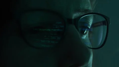 Close-up view of a programmer's eyes, with code projected on their glasses. Video stock 270186862