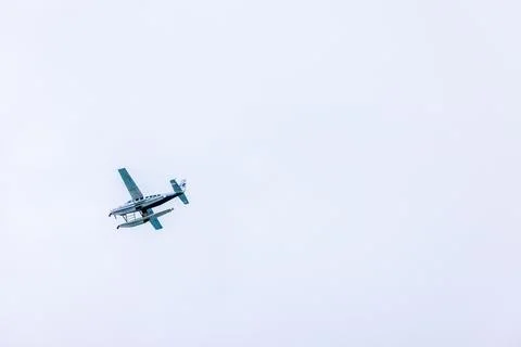 Close up view of propeller floatplane banking in flight against background Stock Photos