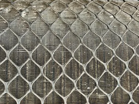Close Up View of Protective Metal Mesh Grid Guard Over Air Conditioner Stock Photos