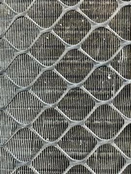 Close Up View of Protective Metal Mesh Grid Guard Over Air Conditioner Stock Photos