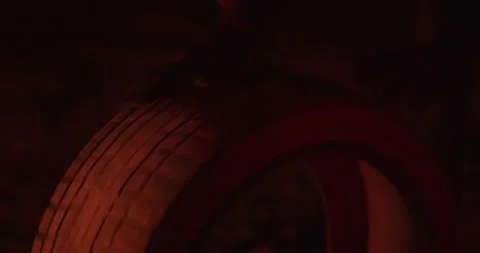 Close view of a protester hands in gloves roll's old tire on the earth near fire Stock Footage 162501650