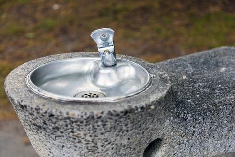 Close-up view of public drinking water fountain in park. Stock-Fotos
